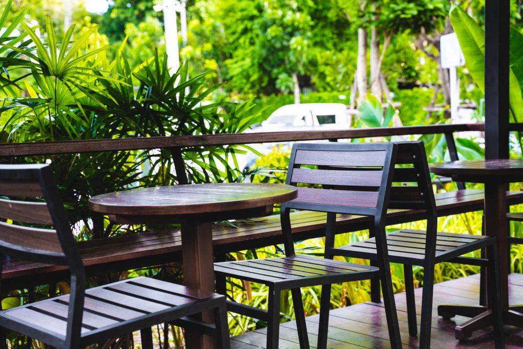 A wooden table and chairs on a wooden deck.