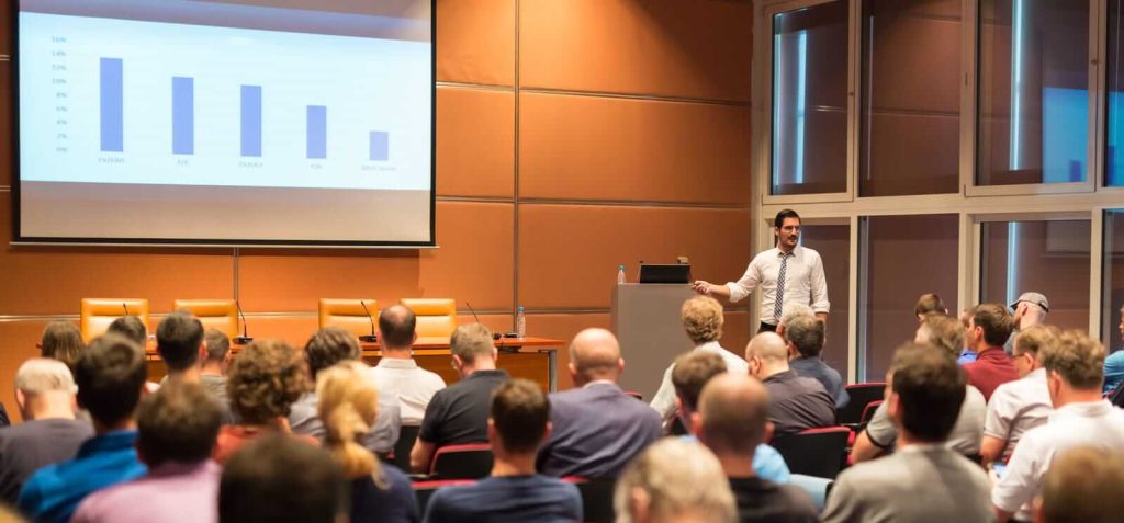 A man giving a presentation to a large audience.