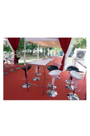 A Barcelona Long Bar Table with chairs and stools on a red carpet.