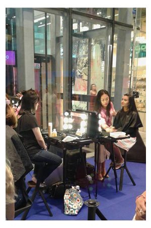 a group of people sitting at a dressing table in front of a window