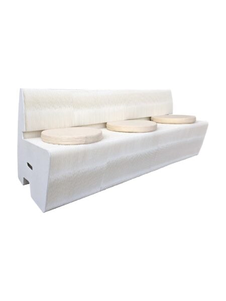 A modern white bench with a ribbed texture and three round, light wood seat cushions placed evenly along the seat.