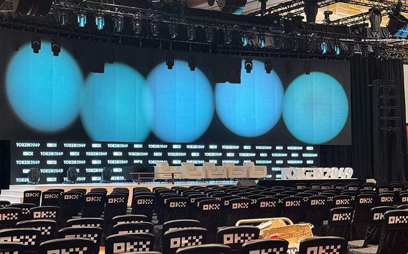 High-volume seminar stage and auditorium seating.