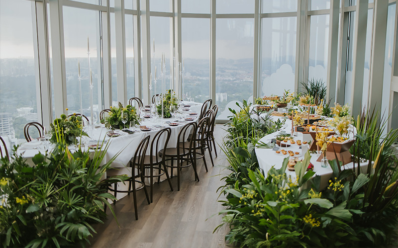 Upscale banquet dining setup with city views.