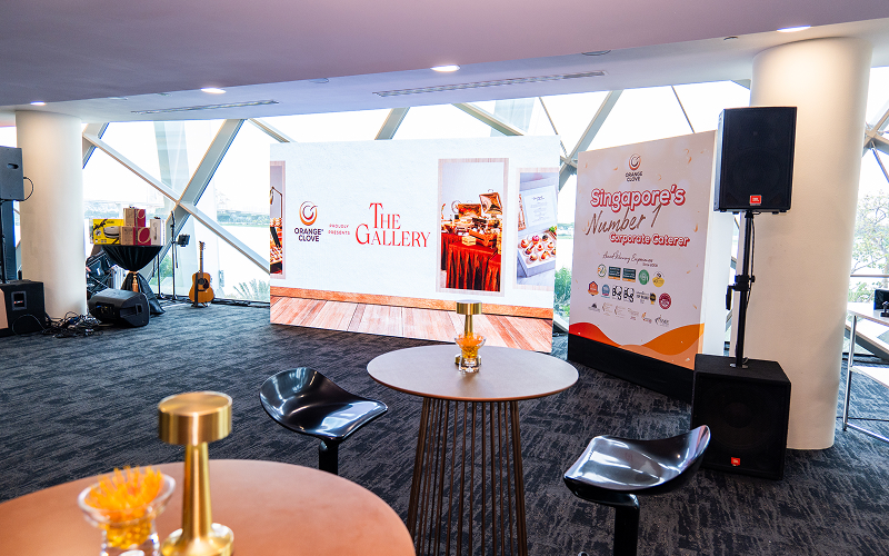 Corporate event space with rented bar tables and chairs.