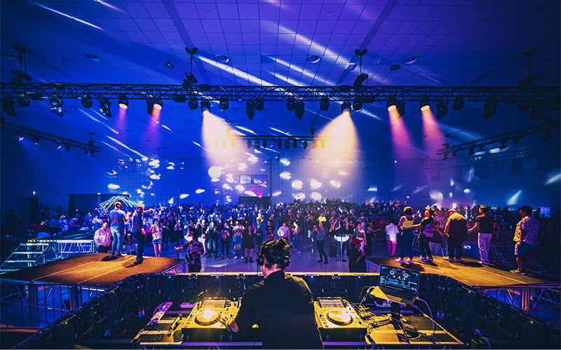 DJ performing at lively indoor party.