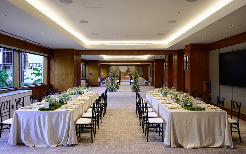 Elegant banquet hall with decorated tables.