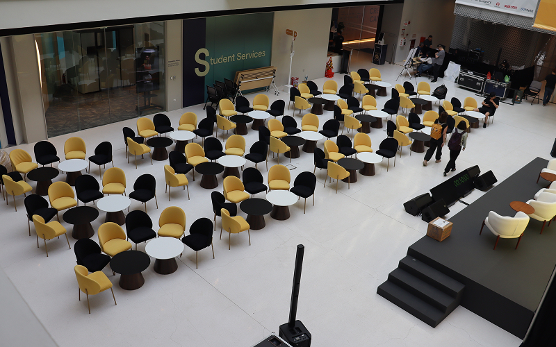 Rows of rented chairs and tables arranged for an event.
